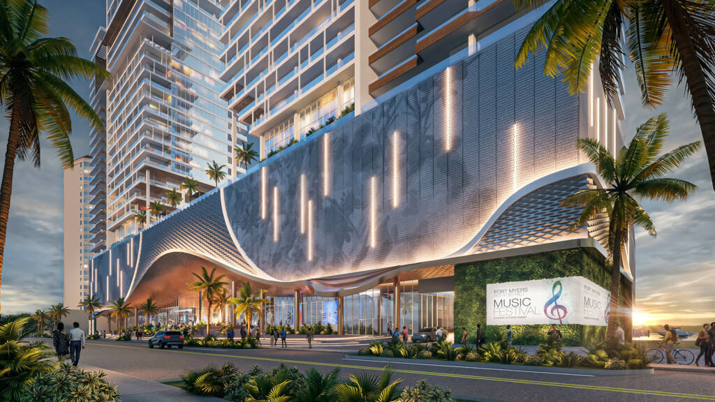 A high-end street-level rendering of the Legacy Harbour Upland development in Fort Myers, FL. The image showcases a grand, modern arched entrance with a glowing honeycomb-textured ceiling and vertical architectural lighting. A lush green living wall on the right displays a sign for the "Fort Myers River District Music Festival". Pedestrians and a cyclist are seen enjoying the palm-lined promenade at sunset, with luxury high-rise towers rising in the background.